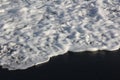 White sea foam and Black Sand, Bali island. Royalty Free Stock Photo