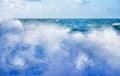 White sea spray of a wave breaking on the beach with a rough sea and sky behind Royalty Free Stock Photo
