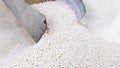 White secondary processing plastic granule comes out of the granulator crusher into small granules. Concept of plastic Royalty Free Stock Photo