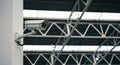 Security Camera Mounted on a White Pillar Inside a Building with Industrial Ceiling surveillance Royalty Free Stock Photo