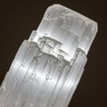 White selenite crystal with a translucent appearance and fibrous texture. The crystal Royalty Free Stock Photo