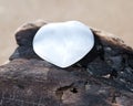 White Selenite Heart from Morocco on the beach