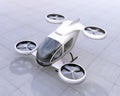 White self-driving passenger drone landing on the ground