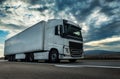 White semi trailer lorry truck on a highway at sunset Royalty Free Stock Photo