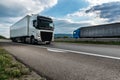 White semi trailer lorry truck passing on a highway at sunset Royalty Free Stock Photo