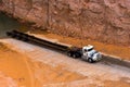 White semi truck and long oversized trailer