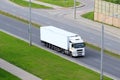 White semi truck with trailer in motion on freeway. Big commercial cargo van, freight car. Branding mockup Royalty Free Stock Photo