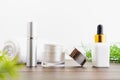 White serum bottle and cream jar, mockup of beauty product brand. Top view on the white background.