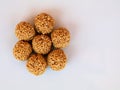 White sesame seed balls made with heated  jiggery against white background Royalty Free Stock Photo