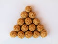 White sesame seed balls made with heated  jiggery against white background Royalty Free Stock Photo