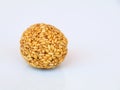 White sesame seed balls made with heated jiggery against white background