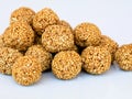 White sesame seed balls made with heated  jiggery against white background Royalty Free Stock Photo