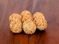 White sesame seed balls made with heated jiggery against wooden background Royalty Free Stock Photo