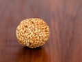 White sesame seed balls made with heated jiggery against wooden background Royalty Free Stock Photo