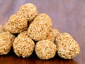 White sesame seed balls made with heated jiggery against wooden background Royalty Free Stock Photo