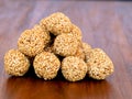 White sesame seed balls made with heated jiggery against wooden background Royalty Free Stock Photo