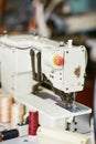 White sewing machine with threads nearby