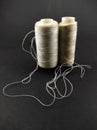 White sewing thread reel isolated on a black - Stock photo Royalty Free Stock Photo