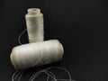 White sewing thread reel isolated on a black - Stock photo Royalty Free Stock Photo