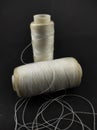 White sewing thread reel isolated on a black - Stock photo Royalty Free Stock Photo