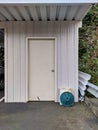 White shed in a backyard garage area, storing gardening and other outdoor tools Royalty Free Stock Photo
