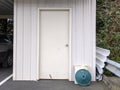 White shed in a backyard garage area, storing gardening and other outdoor tools Royalty Free Stock Photo