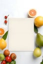 A white sheet, a blank sheet of paper, all around fruit
