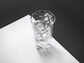 White sheet with glass of water and ice close up. 3d rendering