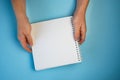 white sheet of Notepad in two hands, copyspace