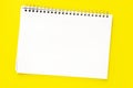 White sheet of an open notebook with a spiral on a yellow background. Layout or mock up. Copy space or space for text. Royalty Free Stock Photo