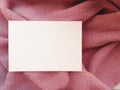 WHITE SHEET OF PAPER ON pink FABRIC