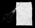 White sheet of paper with scissors on black background Royalty Free Stock Photo