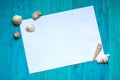 White sheet of paper (space for text), seashells, blue wood Royalty Free Stock Photo