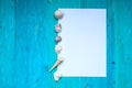 White sheet of paper (space for text), seashells, blue wood Royalty Free Stock Photo