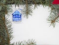 On a white sheet of paper a toy Christmas house Royalty Free Stock Photo