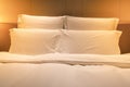 White sheets king size bed with double pillows with warm light