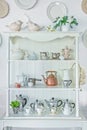 White shelf with vintage porcelain tableware