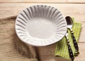 White shell bowl with cutlery and napkins