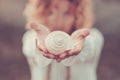 Beautiful woman out of focus take a white shell