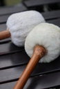White sherpa and fur gong mallets on marimba