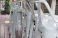 White shiny tall metal stool on terrace of cafe