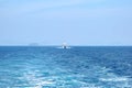 The white ship pursues another ship at sea. Clear sunny day, blue sky