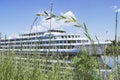 A white ship sails along the river on a clear summer day. Royalty Free Stock Photo