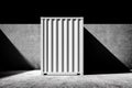 white shipping container stands against dark wall, showcasing its structure and shadows, symbolizing balance of commodity Royalty Free Stock Photo
