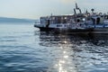 White ships boats on pier in bay of blue lake baikal with glowing and reflections in water in light of sun Royalty Free Stock Photo