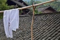A white shirt in the foreground of a small village of ethnic minority Miao hidden in the middle of nowhere in Hunan province Royalty Free Stock Photo