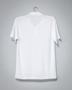 White shirt hanging on cement wall. Blank t-shirt for printing. Back view Royalty Free Stock Photo