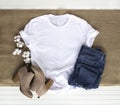 White shirt mockup - tshirt with cotton plant, burlap, boots & jeans Royalty Free Stock Photo