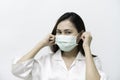 White shirt, woman wearing a medical mask to prevent the flu and Covid-19 corona virus, hand grips, ear strap