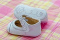 White shoes for baby girl with ornament on the sole